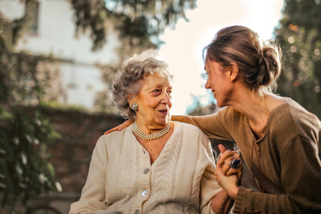 pexels-photo-3768131-3768131 Joyful adult daughter greeting happy surprised senior mother in garden